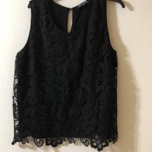 Very pretty black sleeveless blouse with embodied flowers on just the front.